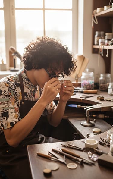 Alex Petrov examining jewelry at the workbench
